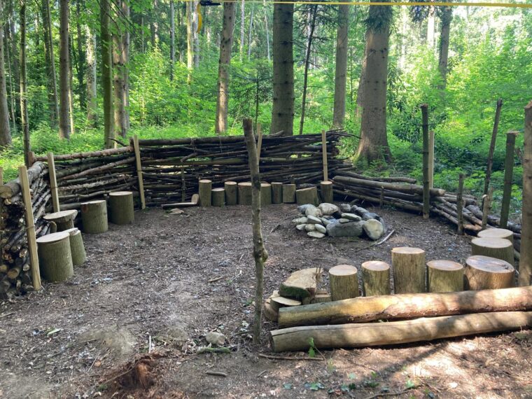 Sitzgelegenheit und Schutzmauer im Wald